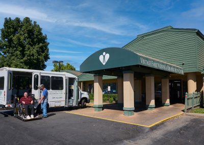 The front entrance of Vintage Faire Nursing and Rehabilitation Center and the bus